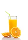 Full glass of orange juice with straw near half orange with space for text