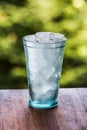 Full glass of water with ice on the wooden kitchen counter. Wodd Royalty Free Stock Photo