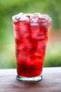 Full glass of water and juice with ice on the wooden kitchen counter. Royalty Free Stock Photo