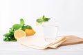 Full glass of fresh cool transparent water with lemon and mint leaves on wooden table, light background Royalty Free Stock Photo