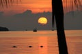 Beautiful sunset of full sun behind clouds low to the horizon behind a fishing boating in Key Largo, Florida Royalty Free Stock Photo