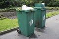 Full green garbage bin on road Royalty Free Stock Photo