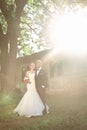 Couples of newlyweds standing near the old manor in the evening Royalty Free Stock Photo