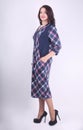 In full growth. elegant young woman in plaid dress