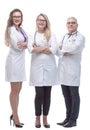 In full growth. a friendly female doctor standing in front of her colleagues. Royalty Free Stock Photo