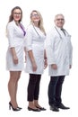 In full growth. a friendly female doctor standing in front of her colleagues. Royalty Free Stock Photo