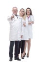 In full growth. a friendly female doctor standing in front of her colleagues. Royalty Free Stock Photo