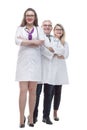 In full growth. a friendly female doctor standing in front of her colleagues. Royalty Free Stock Photo