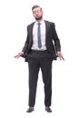 in full growth. frustrated businessman showing his empty pockets Royalty Free Stock Photo