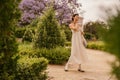 In full growth, pretty young caucasian girl walks in city park summer. Royalty Free Stock Photo