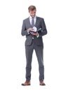 In full growth. young businessman making notes in a notebook. Royalty Free Stock Photo
