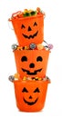 Full Halloween Jack o Lantern candy holders stacked over white Royalty Free Stock Photo