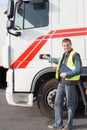 a full handsome truck driver worker in front vehicule Royalty Free Stock Photo