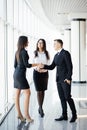 Full height Businessman And businesswoman shaking hands In bright Office Royalty Free Stock Photo