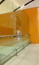 Tempered glass Full height Glass partition along with stainless steel hand rail protection with Orange color background walls