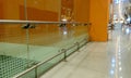 Tempered glass Full height Glass partition along with stainless steel hand rail protection with Orange color background walls