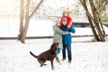 Full height portrait of happy family with one kid and dog in winter casual outfit posing outdoors Royalty Free Stock Photo