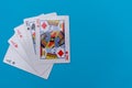 Full house hand of cards on bright blue flat lay in a game of texas holdem poker gambling at a casino concept