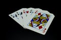 Full house kings over queens cards in poker game against black background Royalty Free Stock Photo