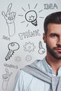 Full of ideas. Vertical half face portrait of a confident bearded man in blue shirt looking at camera while standing Royalty Free Stock Photo