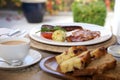 A full Irish breakfast consisting of bacon, egg, sausage, black pudding and grilled tomato. Royalty Free Stock Photo