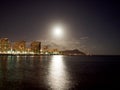 Full Large Moon hangs over Diamond Head Crater, Waikiki hotels, and Marina Royalty Free Stock Photo
