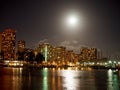 Full Large Moon hangs over Waikiki hotels and Marina at Night Royalty Free Stock Photo