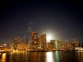 Full Large Moon raises over Waikiki hotels and Marina at Night Royalty Free Stock Photo