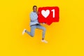Full legth photo of young popular lady jumping air holding big red heart social media isolated on yellow color