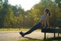 Full lenght portrait of beautiful fitness woman doing park bench push-ups. Royalty Free Stock Photo