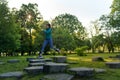 Full lenght portrait of beautiful fitness woman jumping on concrete obstacles in the park. Royalty Free Stock Photo