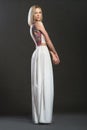 Full-lenght portrait of bnonde woman in white long dress Royalty Free Stock Photo