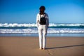 Full lenght portrait of young woman enjoy ocean on beach