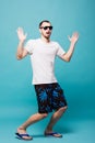 Full lenght young summer man in sunglasses pointing up while looking away in isolated on green background Royalty Free Stock Photo