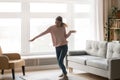 Full-length of active young woman dancing in living room Royalty Free Stock Photo