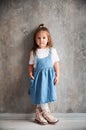 Little girl standing by the wall in new apartment. Royalty Free Stock Photo