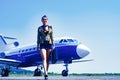 Full length of airhostess on private jet airplane on airport. Airline. Airplane and woman. Charming stewardess Royalty Free Stock Photo