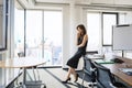 Full length of an attractive businesswoman standing in a modern office