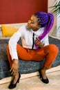 Full length of attractive woman with blue hair in stylish clothing. African female fashion model Royalty Free Stock Photo