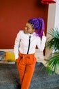 Full length of attractive woman with blue hair in stylish clothing. African female fashion model Royalty Free Stock Photo