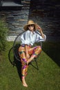 Full length of an attractive woman wearing sunhat and sunglasses while relaxing outdoor Royalty Free Stock Photo