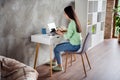 Full length back rear spine view profile side photo of korean girl sit table work remote laptop have online colleagues Royalty Free Stock Photo