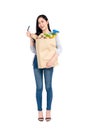 Smiling Asian woman holding grocery shopping bag Royalty Free Stock Photo