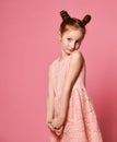 Full length of beautiful little girl in dress standing and posing over pink background Royalty Free Stock Photo