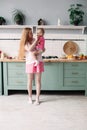 Mother having breakfast with her lovely daughter in the kitchen. Royalty Free Stock Photo