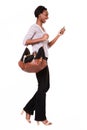 Full length beautiful tall african american woman with purse and smart phone Royalty Free Stock Photo