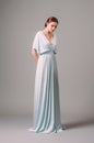 Full-length blue bridesmaid dress with flutter sleeves. Effortless festive summer look. Ginger lady