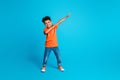 Full length body cadre of small boy kindergarten moves dab sign have fun dab demonstration dancing isolated on blue Royalty Free Stock Photo