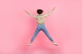 Full length body photo of jumping trampoline sportive girl hands up showing body star symbol rear view isolated on pink