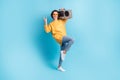 Full length body side profile photo of girl showing heavy metal sign horns keeping boombox isolated on bright blue color